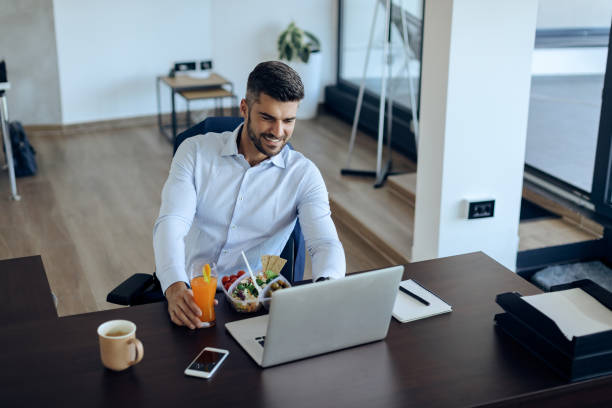 istock Happy entrepreneur enjoying while surfing the net on laptop during lunch break. 1271164018