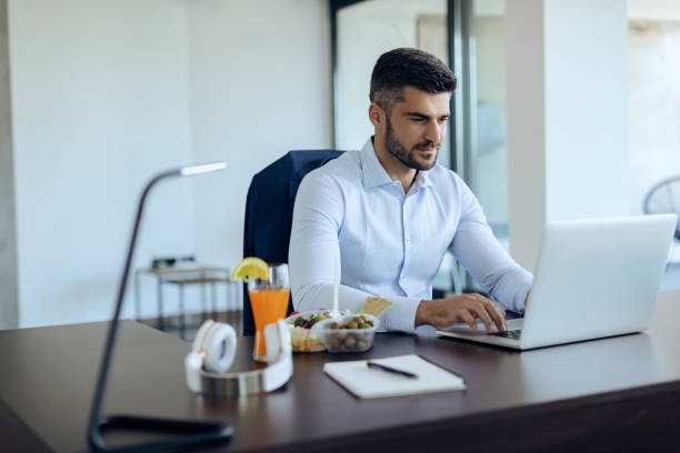istock Young businessman typing an e-mail on laptop while working in the office. 1271164133