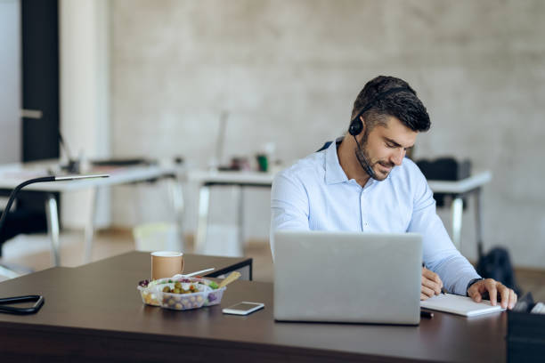 istock Male entrepreneur taking notes while working on laptop in the office. 1271164255