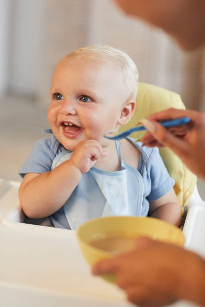 istock Woman Feeding Her Happy Baby 1271167383