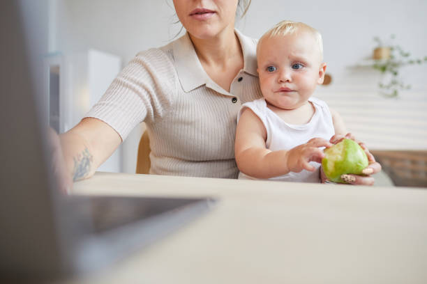 istock Young Mother Working On Laptop 1271167489