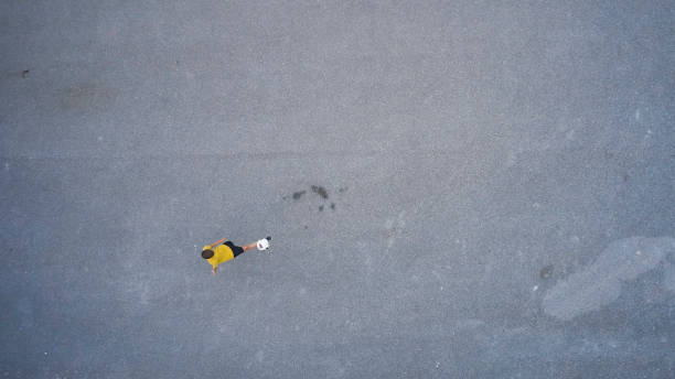 istock boy playing soccer in the street 1271170384