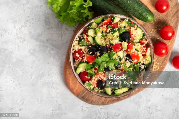 Salad With Couscous And Vegetables In A Bowl On A Gray Concrete Background Stock Photo - Download Image Now
