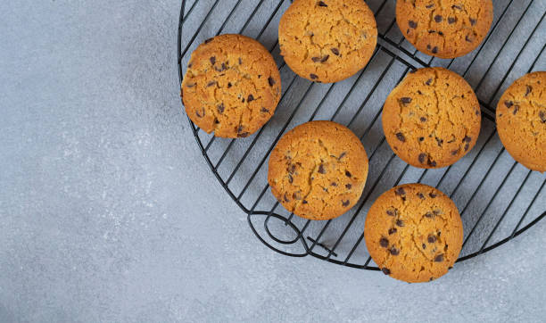 istock Homemade chocolate chip cookies on cooling wire rack top view 1271174480