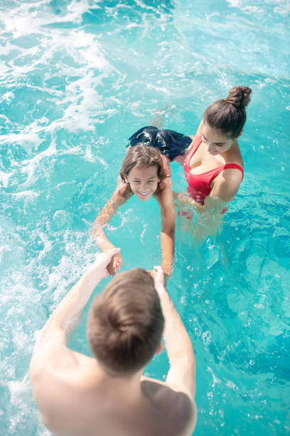 istock Dad and mom teaching their son to swim 1271174572