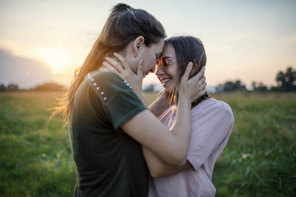 istock Embracing lesbian couple in nature 1271177582