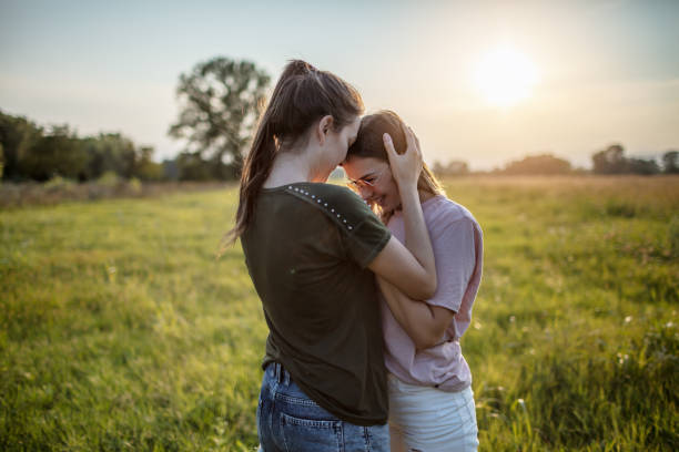 istock Embracing lesbian couple in nature 1271177653