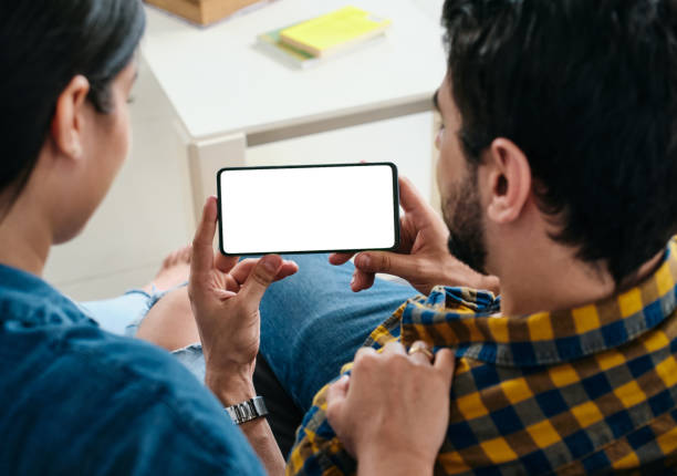 istock Young Couple Holding Phone With Blank Screen For Copy Space 1271177691