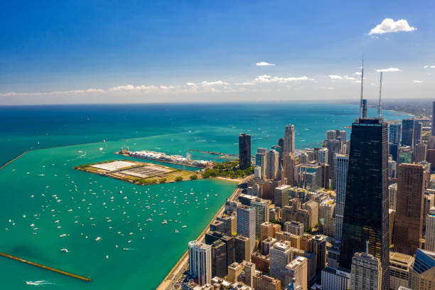 Chicago Cityscape and Lake Michigan in Summer Aerial Panorama of Chicago Cityscape in Summer - Lake Shore Drive lake shore drive chicago stock pictures, royalty-free photos & images