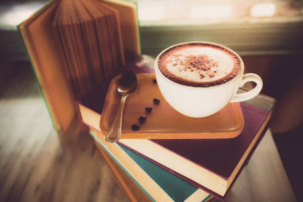 istock Cappuccino coffee cup on book in coffee shop 1271180255