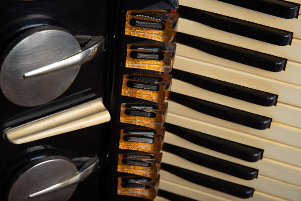 istock Old accordion on rustic wooden surface with black background and Low key lighting, selective focus. 1271180384