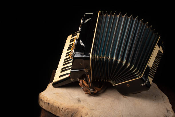 istock Old accordion on rustic wooden surface with black background and Low key lighting, selective focus. 1271180428