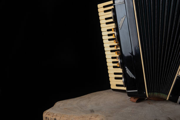 istock Old accordion on rustic wooden surface with black background and Low key lighting, selective focus. 1271180429