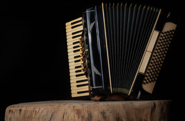 istock Old accordion on rustic wooden surface with black background and Low key lighting, selective focus. 1271180459