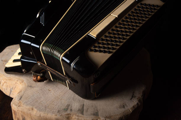 istock Old accordion on rustic wooden surface with black background and Low key lighting, selective focus. 1271180477