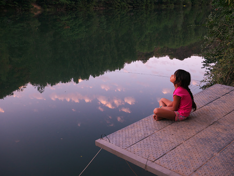 Several summer evenings during the vacations at the campsite, the little one sits on the pontoon to watch the river and to calm down near the water and the nature