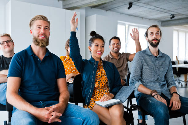 istock Business colleagues with hand raised at workplace 1271182563