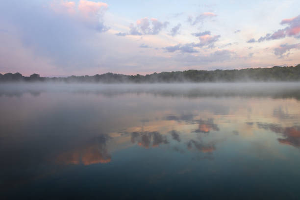 istock Fog lifts off the lake with dramatic cloudscape at sunrise 1271183195