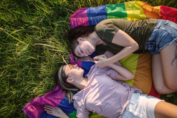 istock Lesbian couple with lgbt flag on grass 1271183327