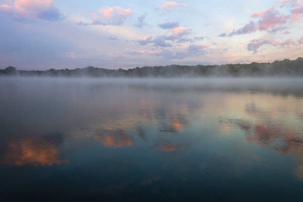 istock Fog lifts off the lake with dramatic cloudscape at sunrise 1271183342