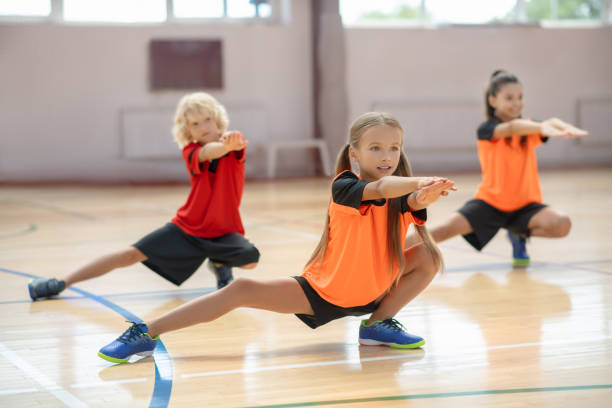 istock Three kids exercising in the gym and looking concentrated 1271183684