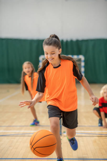 istock A girl running with a ball and looking involved 1271183796