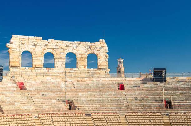 The Verona Arena interior inside view with stone stands. Roman amphitheatre Arena di Verona The Verona Arena interior inside view with stone stands. Roman amphitheatre Arena di Verona ancient building, sunny day, blue sky, Verona city historical centre, Veneto Region, Northern Italy verona opera stock pictures, royalty-free photos & images