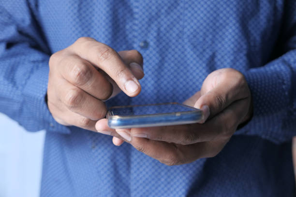 istock Businessman hand holding smart phone texting message 1271184790