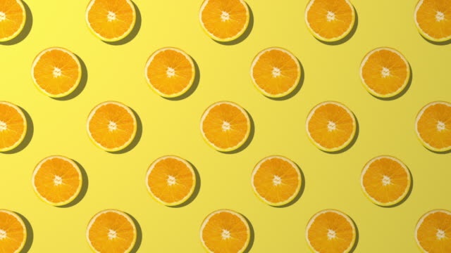 Orange slice spinning pattern on yellow background
