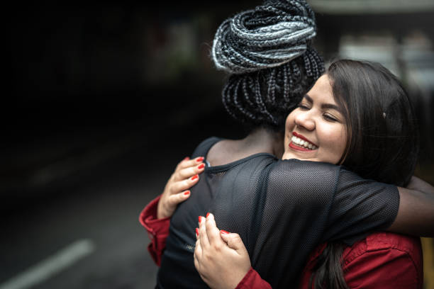 Friends embracing on the street