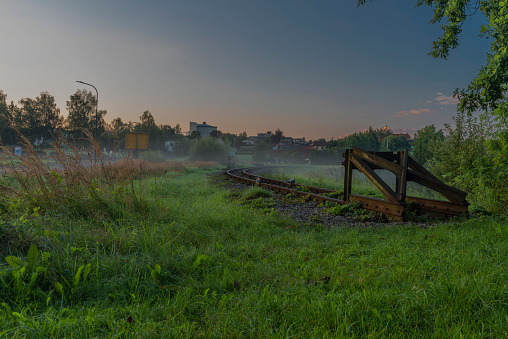 Narrow gauge railway near Gmund station in north Austria with mist and color sunrise