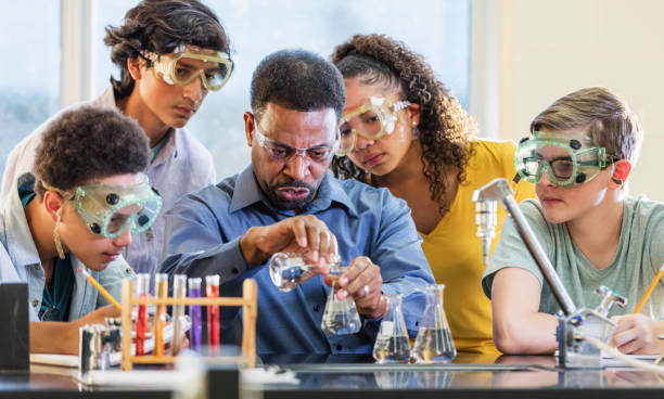 istock Multi-ethnic teacher and students in chemistry lab 1271187055