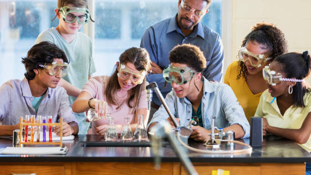 istock Students doing chemistry experiment as teacher watches 1271187117