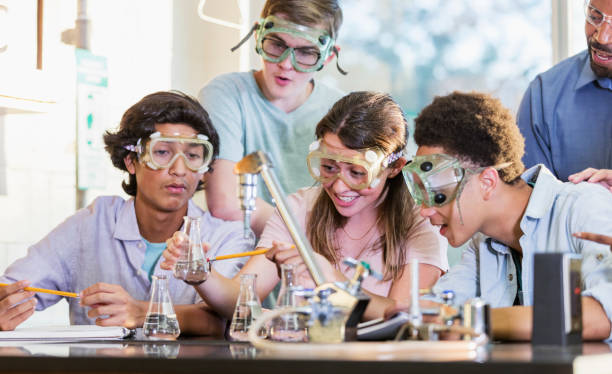 istock Students doing chemistry experiment as teacher watches 1271187184