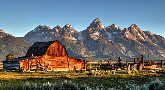 A beautiful sunrise upon the Tetons and one of the famous barns on Mormon Row in the Teton Valley.