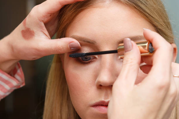 istock Makeup artist creates voluminous eyelashes of the model. 1271187730