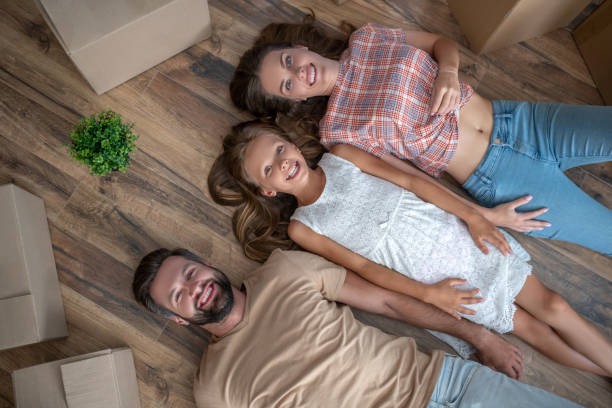 istock Young happy family lying on the floor 1271188457