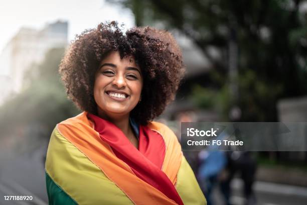 Portrait Of A Happy Woman Wearing The Rainbow Flag Stock Photo - Download Image Now - LGBTQIA Pride Event, LGBTQIA Rights, Pride