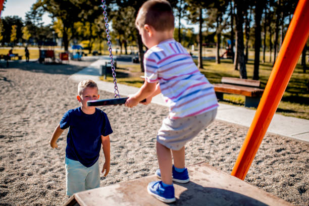 istock Brothers playing in public park during summer day 1271189128