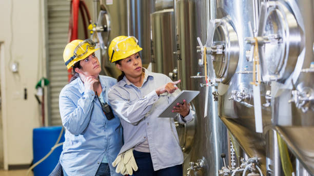 istock Two women working in factory, with digital tablet 1271189887