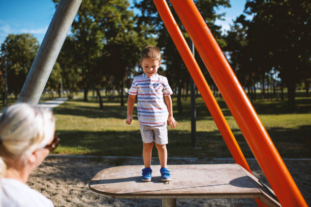 istock Cute Caucasian boy having fun with grandmother outside 1271190042