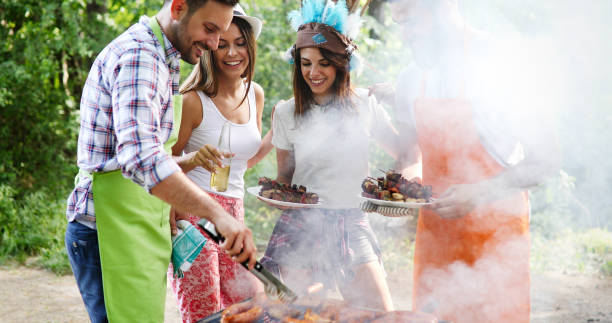 istock Friends having a barbecue party in nature 1271190067