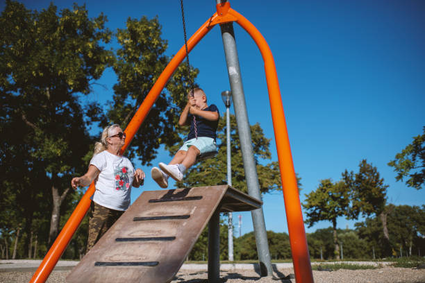 istock Cute Caucasian boy having fun with grandmother outside 1271191242