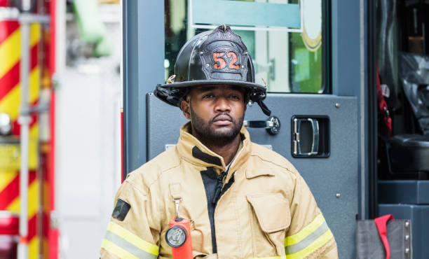 istock Firefighter in protective clothing outside fire truck 1271191648