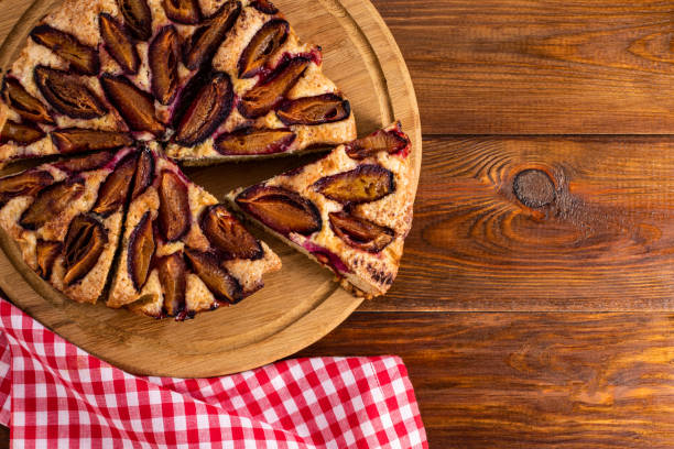 istock plum cake on wood background with copy space 1271194385