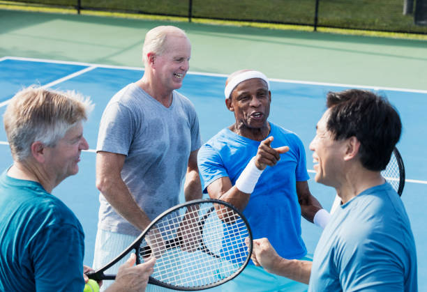 istock Men playing tennis, conversing at the net 1271195280