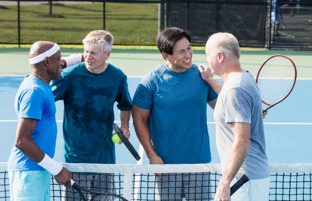 istock Men playing tennis, conversing at the net 1271195294