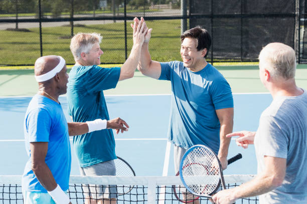 istock Men having fun playing tennis, high-five 1271195299