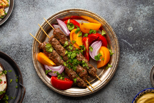 istock Delicious meat kebab with fresh vegetable salad 1271195373