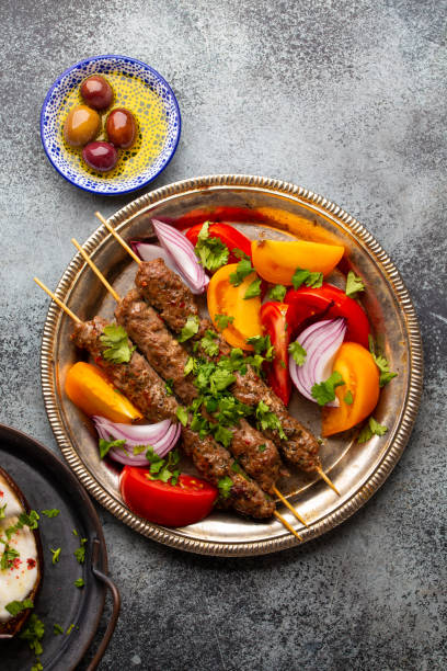 istock Delicious meat kebab with fresh vegetable salad 1271195376